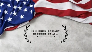 American Flag that says "In Memory of Many, In Honor of All"